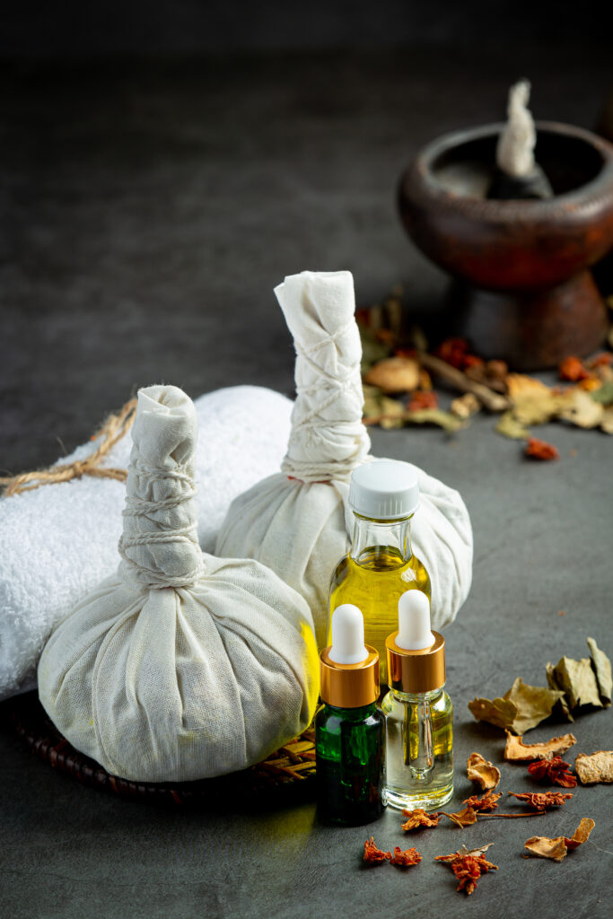 herbal compress and herbal spa treatment equipments put on dark